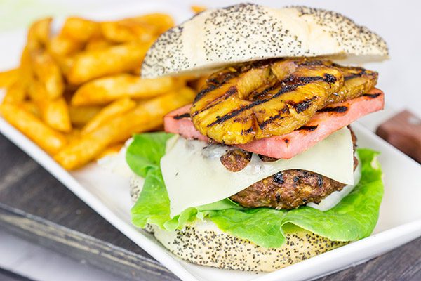 Piled high with teriyaki pineapples and grilled ham, this Grilled Aloha Burger deserves a spot on your dinner menu!