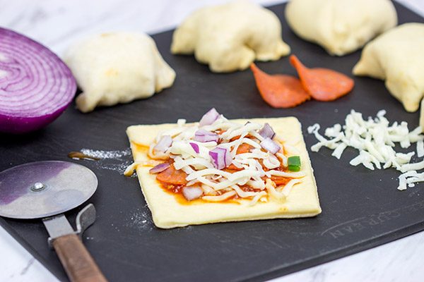 Who says pizza needs to be served by the slice? These Stuffed Pepperoni Pizza Rolls are a tasty twist on a classic!