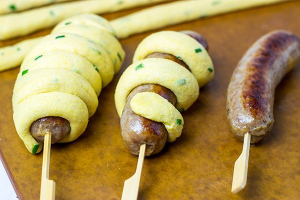Take this street food to a whole new level with these Baked Cheddar Brat Corndogs!