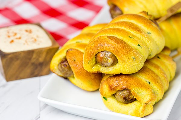 Take this street food to a whole new level with these Baked Cheddar Brat Corndogs!