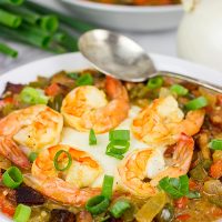 These Charleston Shrimp and Grits feature a bed of creamy grits topped with flavorful shrimp and Andouille sausage!