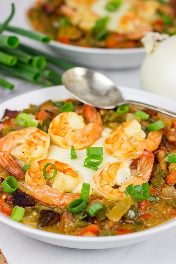 These Charleston Shrimp and Grits feature a bed of creamy grits topped with flavorful shrimp and Andouille sausage!