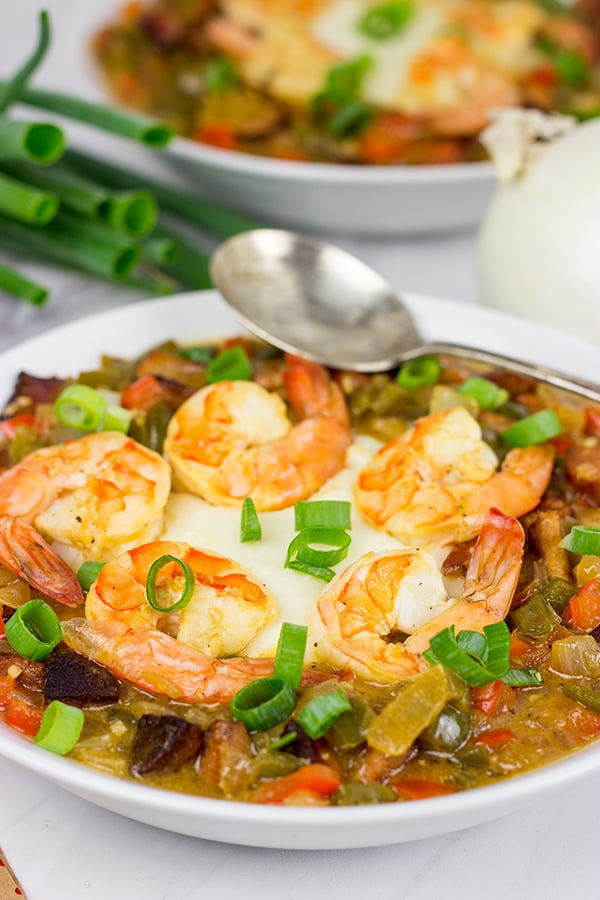 These Charleston Shrimp and Grits feature a bed of creamy grits topped with flavorful shrimp and Andouille sausage!