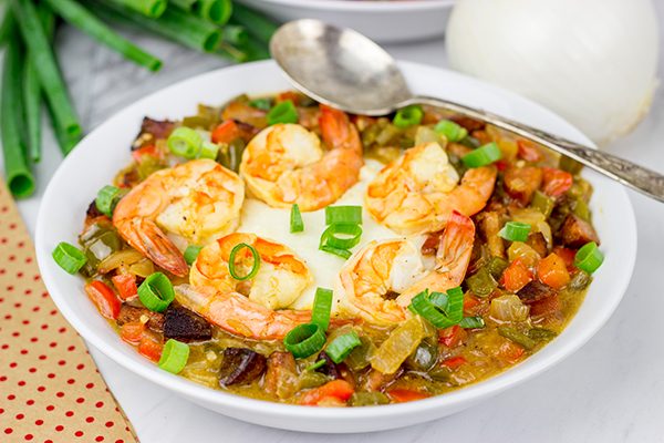 These Charleston Shrimp and Grits feature a bed of creamy grits topped with flavorful shrimp and Andouille sausage!