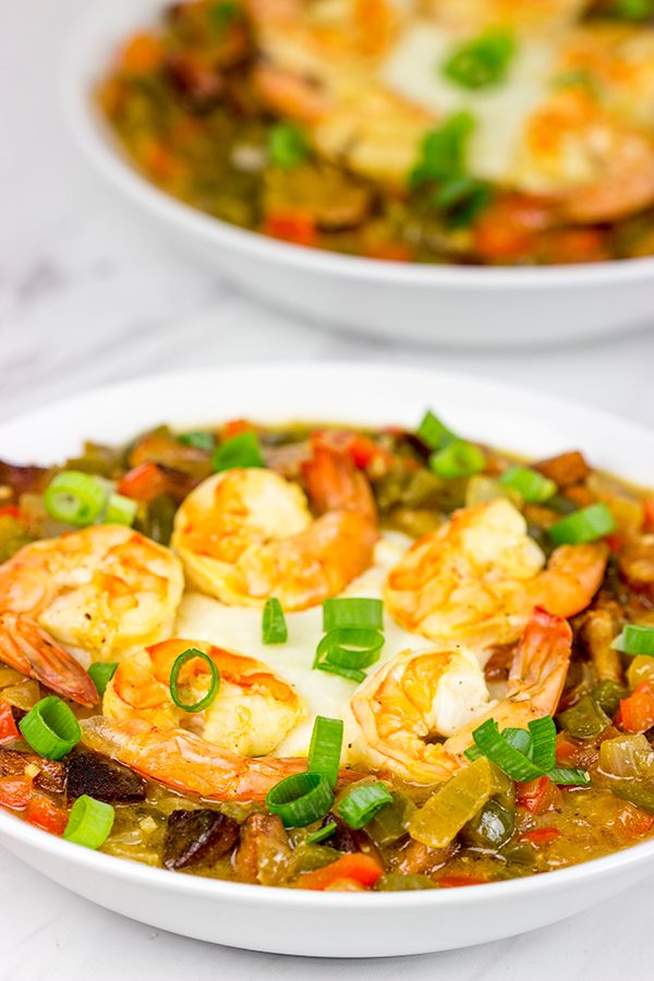 These Charleston Shrimp and Grits feature a bed of creamy grits topped with flavorful shrimp and Andouille sausage!