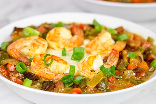 These Charleston Shrimp and Grits feature a bed of creamy grits topped with flavorful shrimp and Andouille sausage!