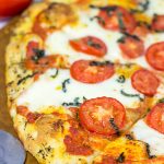 This Classic Pizza Margherita features slices of Roma tomatoes and fresh mozzarella. This recipe is perfect for curling up on the couch and watching a movie!