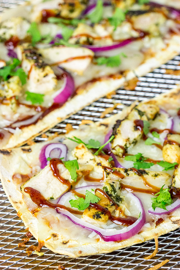 Want to surprise your family with a delicious dinner? Try whipping up a batch of these BBQ Chicken Flatbread Pizzas!
