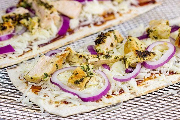 Want to surprise your family with a delicious dinner? Try whipping up a batch of these BBQ Chicken Flatbread Pizzas!