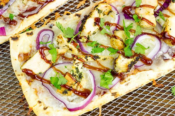 Want to surprise your family with a delicious dinner? Try whipping up a batch of these BBQ Chicken Flatbread Pizzas!