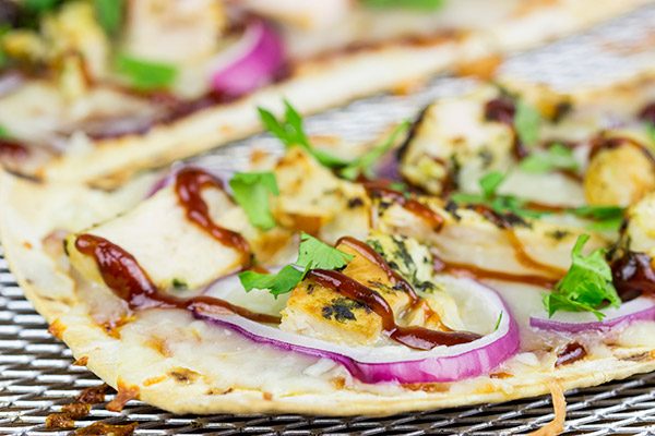 Want to surprise your family with a delicious dinner? Try whipping up a batch of these BBQ Chicken Flatbread Pizzas!