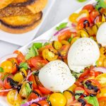 Ever tried burrata cheese? It's in the mozzarella family, and it makes for a great centerpiece of this Tomato and Burrata Caprese!