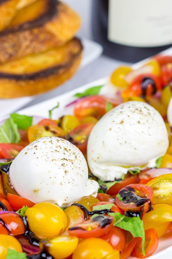 Ever tried burrata cheese? It's in the mozzarella family, and it makes for a great centerpiece of this Tomato and Burrata Caprese!