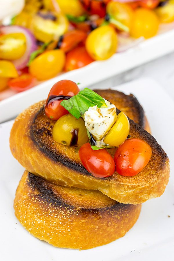 Ever tried burrata cheese? It's in the mozzarella family, and it makes for a great centerpiece of this Tomato and Burrata Caprese!