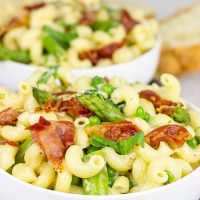 This Creamy Pasta Alfredo is served with asparagus and peas...and topped with crispy prosciutto!