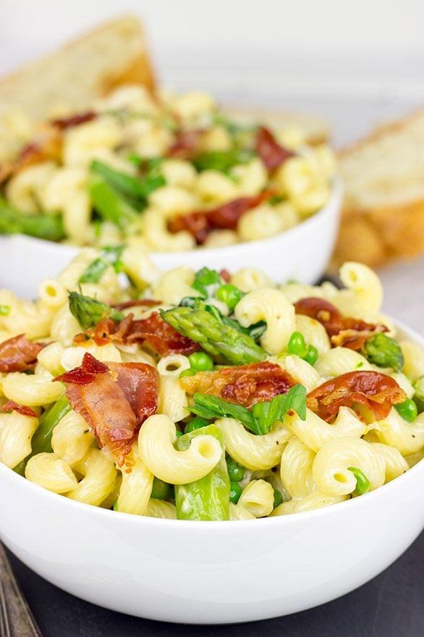 This Creamy Pasta Alfredo is served with asparagus and peas...and topped with crispy prosciutto!