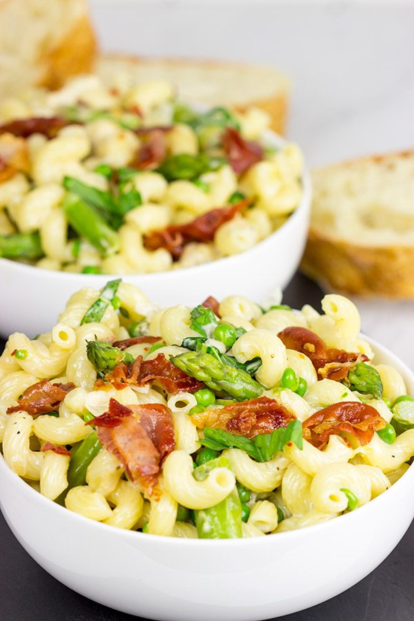 This Creamy Pasta Alfredo is served with asparagus and peas...and topped with crispy prosciutto!