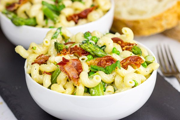 This Creamy Pasta Alfredo is served with asparagus and peas...and topped with crispy prosciutto!