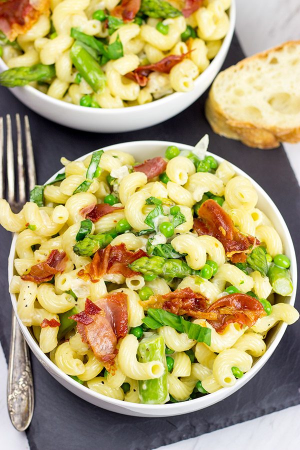 This Creamy Pasta Alfredo is served with asparagus and peas...and topped with crispy prosciutto!