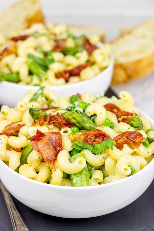 This Creamy Pasta Alfredo is served with asparagus and peas...and topped with crispy prosciutto!
