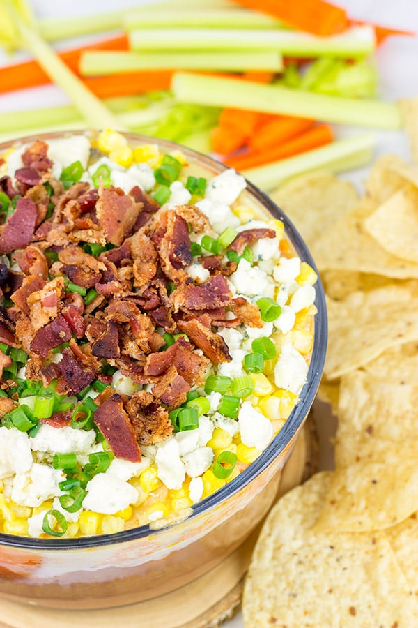 Complete with spicy buffalo chicken, creamy refried beans and crunchy bacon, this 7-Layer Buffalo Chicken Dip is a surefire party favorite!