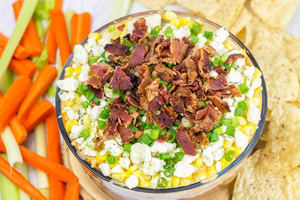 Complete with spicy buffalo chicken, creamy refried beans and crunchy bacon, this 7-Layer Buffalo Chicken Dip is a surefire party favorite!