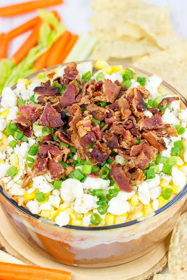 Complete with spicy buffalo chicken, creamy refried beans and crunchy bacon, this 7-Layer Buffalo Chicken Dip is a surefire party favorite!