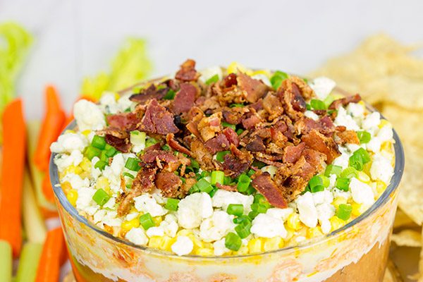 Complete with spicy buffalo chicken, creamy refried beans and crunchy bacon, this 7-Layer Buffalo Chicken Dip is a surefire party favorite!