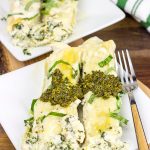 This tasty Pesto Chicken Manicotti is baked in a creamy alfredo sauce and then topped with fresh basil pesto!