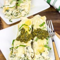 This tasty Pesto Chicken Manicotti is baked in a creamy alfredo sauce and then topped with fresh basil pesto!
