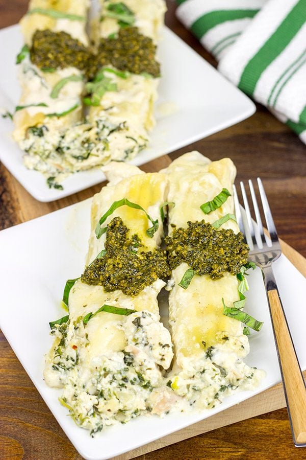 This tasty Pesto Chicken Manicotti is baked in a creamy alfredo sauce and then topped with fresh basil pesto!