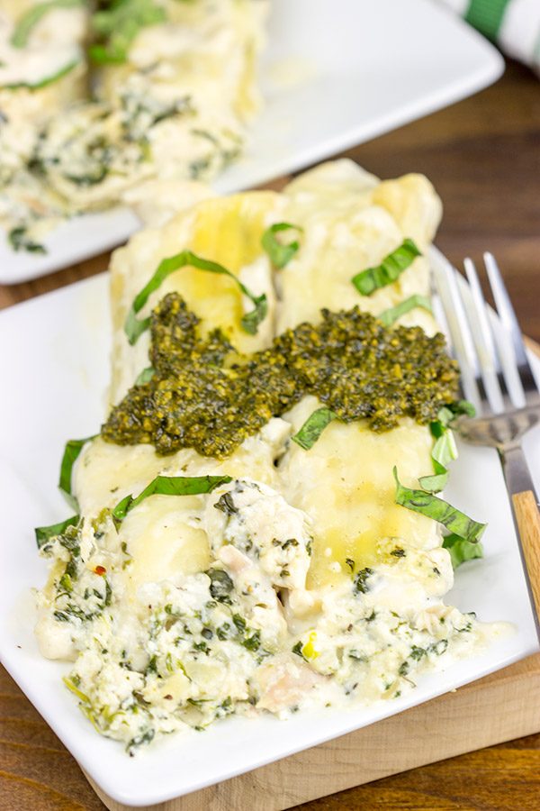 This tasty Pesto Chicken Manicotti is baked in a creamy alfredo sauce and then topped with fresh basil pesto!