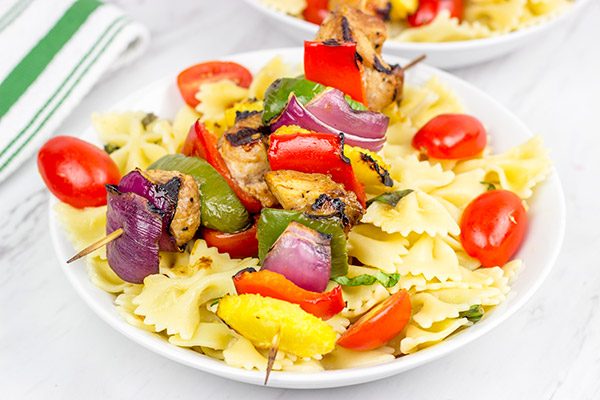 These Grilled Pork Kabobs are served over pasta for a fun and tasty summer meal!