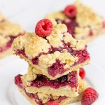 These Raspberry Crumb Bars feature fresh or frozen berries...and they're the perfect fruity dessert for a warm summer day!