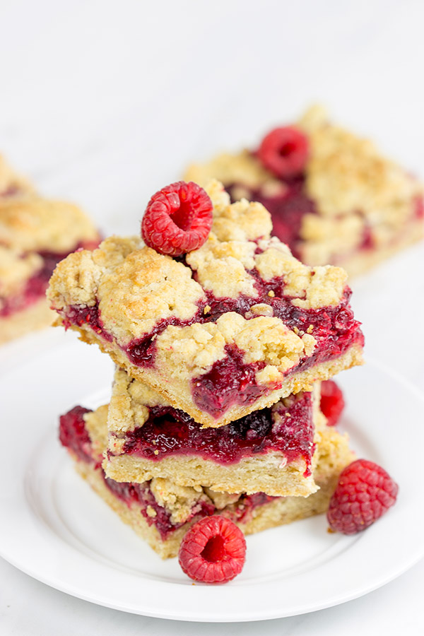 These Raspberry Crumb Bars feature fresh or frozen berries...and they're the perfect fruity dessert for a warm summer day!