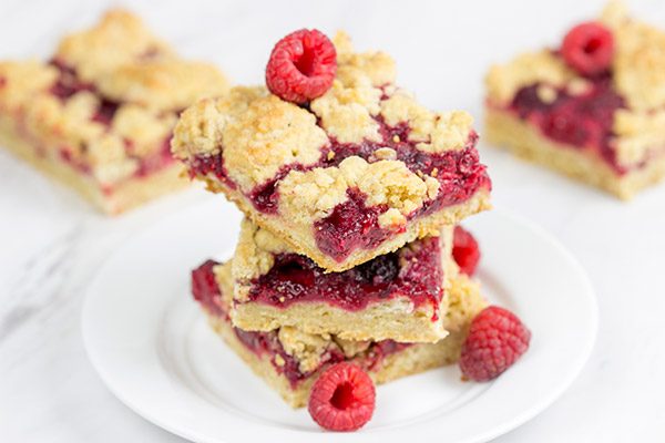 These Raspberry Crumb Bars feature fresh or frozen berries...and they're the perfect fruity dessert for a warm summer day!