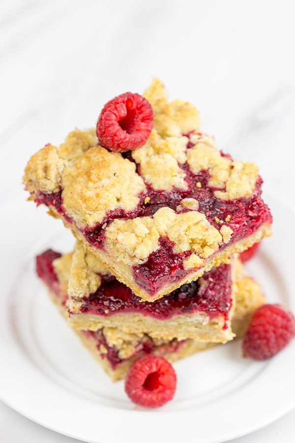 These Raspberry Crumb Bars feature fresh or frozen berries...and they're the perfect fruity dessert for a warm summer day!