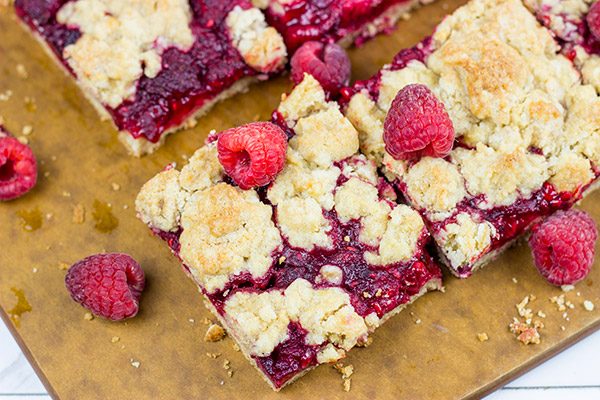 These Raspberry Crumb Bars feature fresh or frozen berries...and they're the perfect fruity dessert for a warm summer day!
