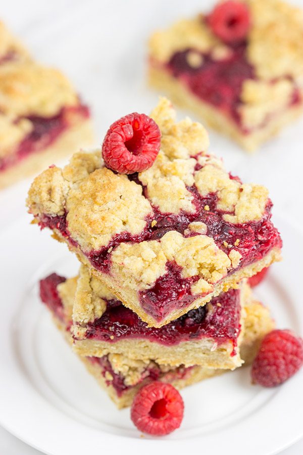 These Raspberry Crumb Bars feature fresh or frozen berries...and they're the perfect fruity dessert for a warm summer day!