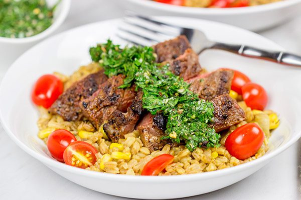 Looking for a delicious summer meal? This Grilled Flank Steak with Porcini Mushroom Pilaf will make you look like a superstar chef!