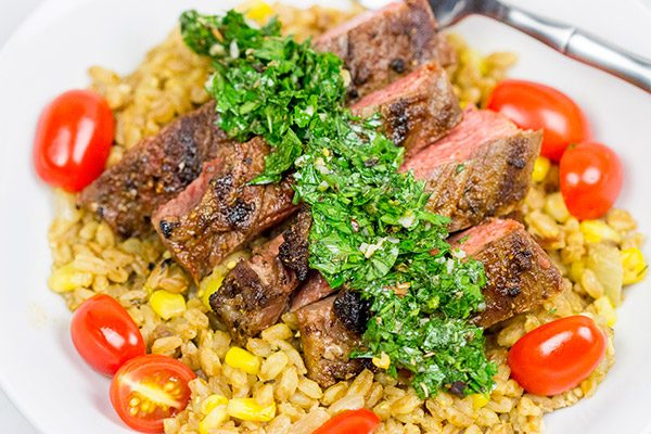 Looking for a delicious summer meal? This Grilled Flank Steak with Porcini Mushroom Pilaf will make you look like a superstar chef!