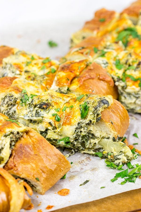 This Spinach Artichoke Stuffed French Bread is a tasty appetizer to serve while watching your favorite sport on tv!