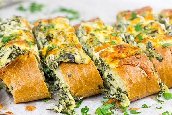 This Spinach Artichoke Stuffed French Bread is a tasty appetizer to serve while watching your favorite sport on tv!