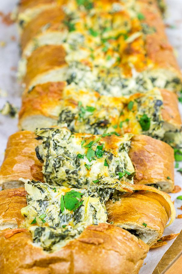 This Spinach Artichoke Stuffed French Bread is a tasty appetizer to serve while watching your favorite sport on tv!