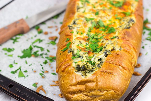 This Spinach Artichoke Stuffed French Bread is a tasty appetizer to serve while watching your favorite sport on tv!