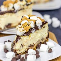 It might be chilly outside, but this S'mores Cheesecake is loaded with chocolate, marshmallow and graham crackers...and it's sure to remind you of a summer campfire!