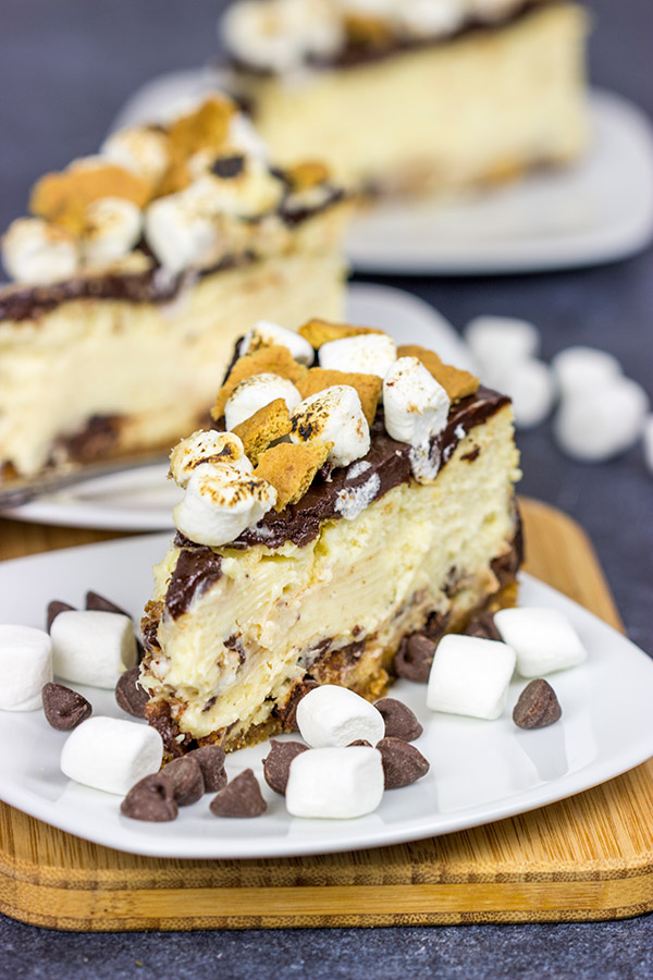 It might be chilly outside, but this S'mores Cheesecake is loaded with chocolate, marshmallow and graham crackers...and it's sure to remind you of a summer campfire!