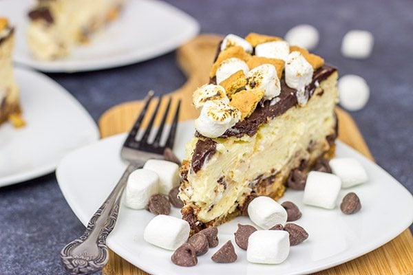 It might be chilly outside, but this S'mores Cheesecake is loaded with chocolate, marshmallow and graham crackers...and it's sure to remind you of a summer campfire!