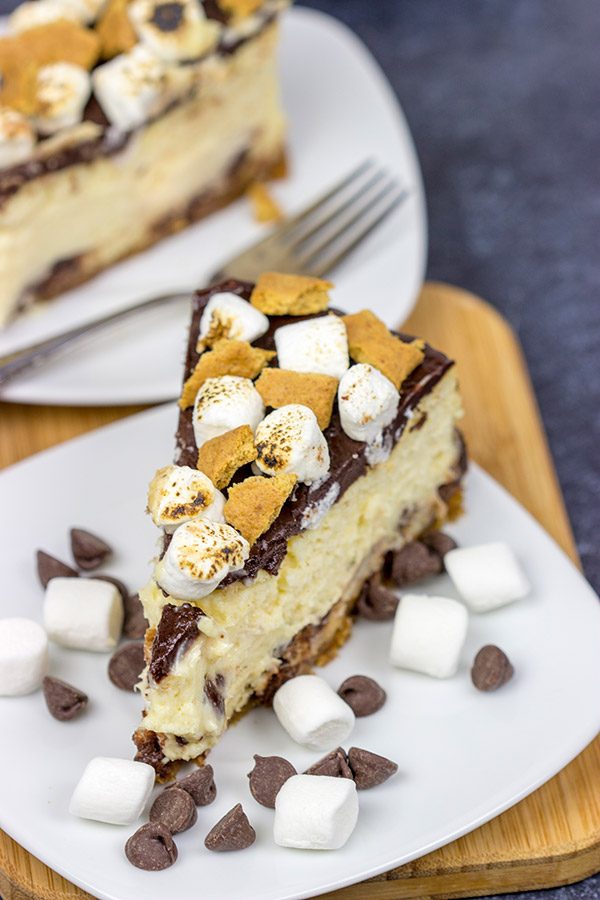 It might be chilly outside, but this S'mores Cheesecake is loaded with chocolate, marshmallow and graham crackers...and it's sure to remind you of a summer campfire!