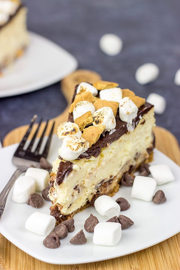 It might be chilly outside, but this S'mores Cheesecake is loaded with chocolate, marshmallow and graham crackers...and it's sure to remind you of a summer campfire!